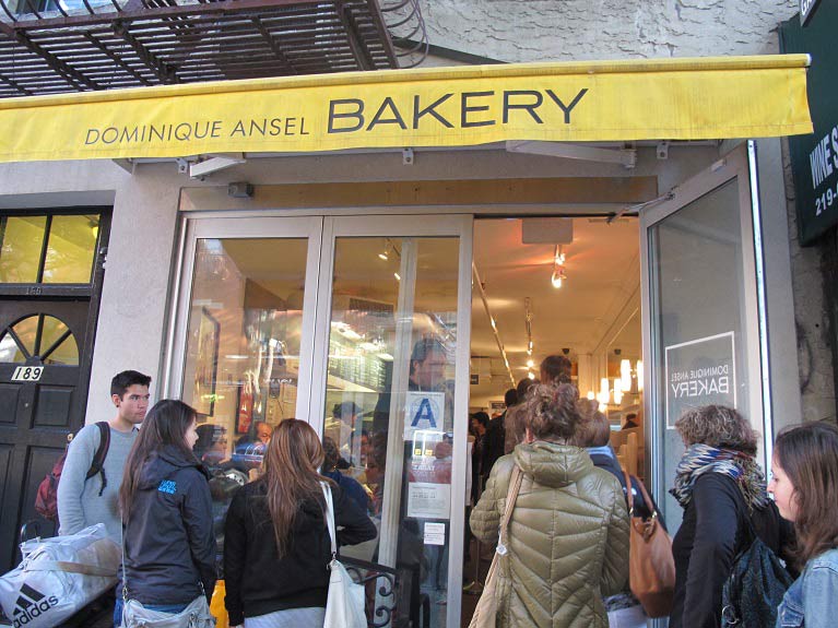 The entrance of Dominique Ansel Bakery crowded with customers.